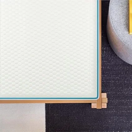 Person testing medium-firm comfort level on Helix Sunset queen mattress