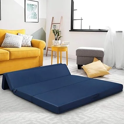 KOMFOTT folding mattress set up as guest bed in living room