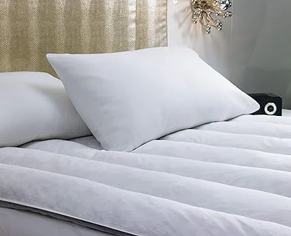 Close-up of soft duck feathers in luxurious hotel-grade featherbed