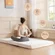 White twin MLILY memory foam mattress topper on a bed frame for added comfort