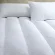 W Hotels white featherbed mattress cover on queen bed